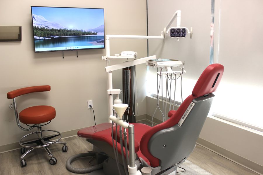 Modern private treatment room at Roscoe Mason Dental in Winnetka, with an overhead TV for patient comfort