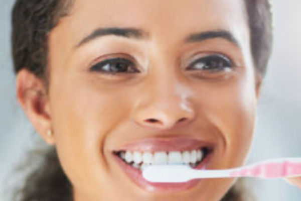 Dental hygienist performing a routine teeth cleaning at Roscoe Mason Dental in Winnetka, CA